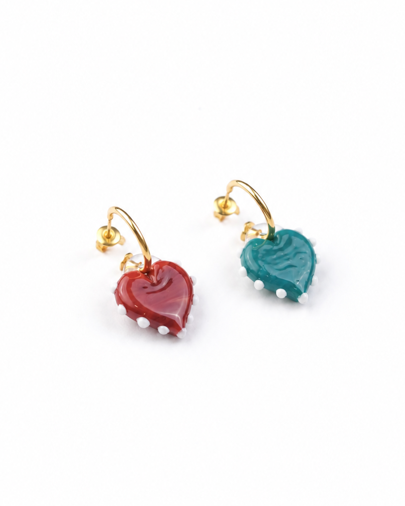 Pair of heart-shaped earrings with gold hooks on a white background