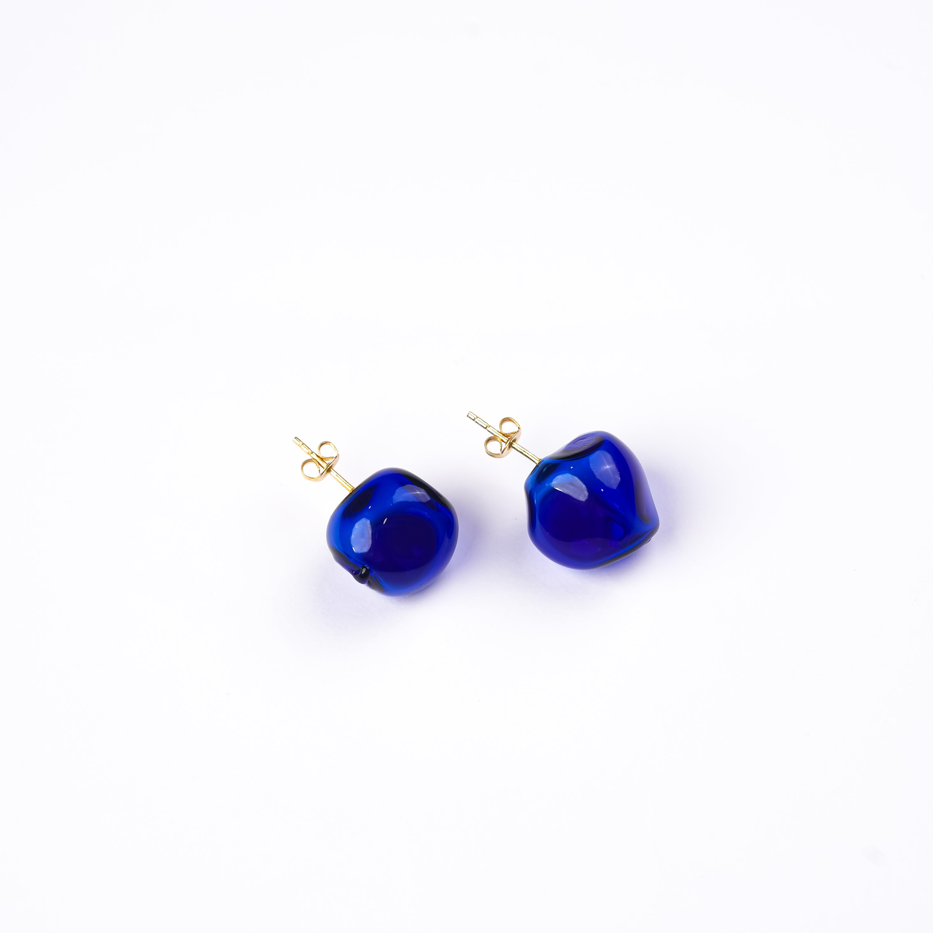 Handmade borosilicate glass amorphous studs in blue by AIROKAD STUDIO.