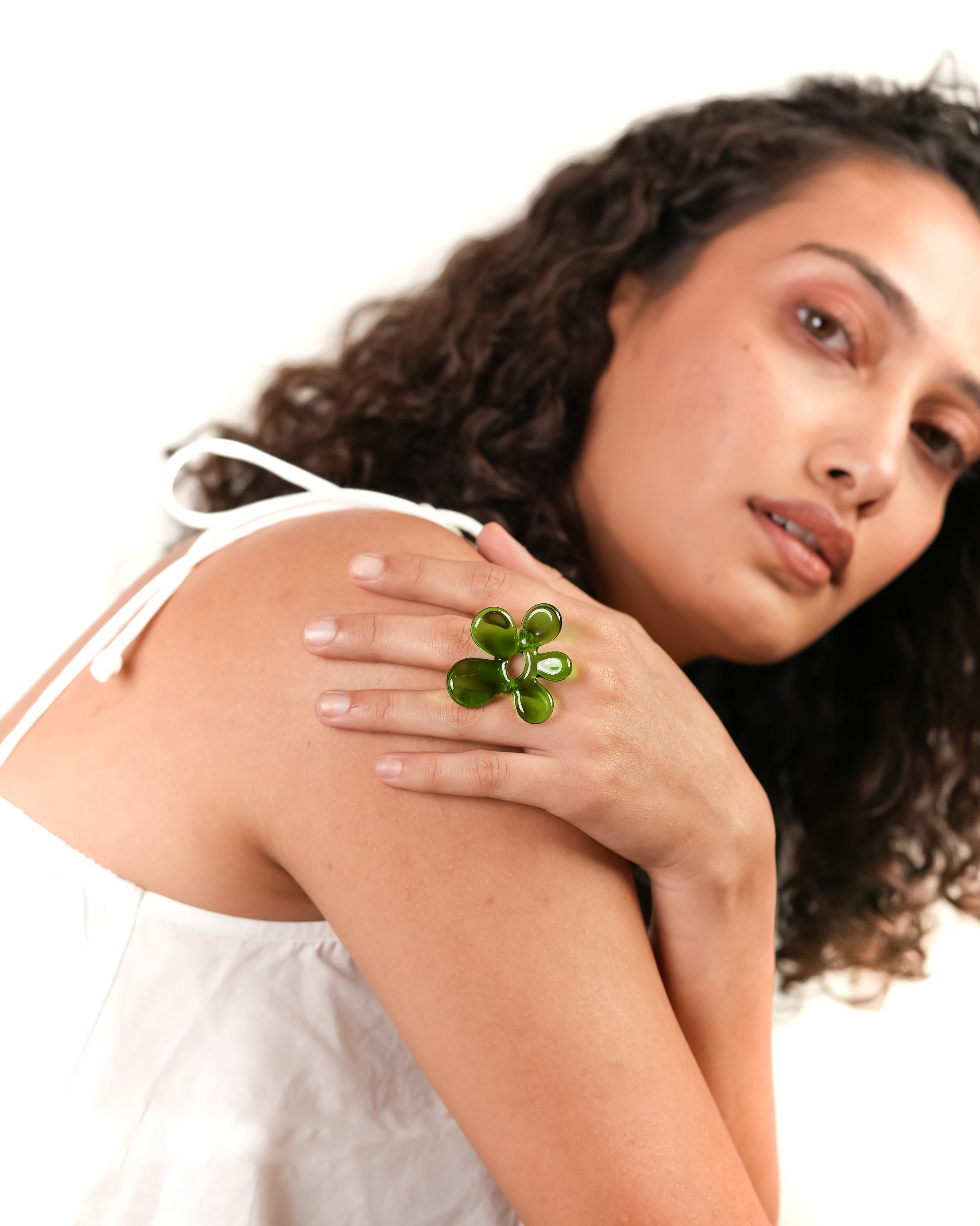 model wearing green flower ring handmade with borosilicate glass by AIROKAD STUDIO.