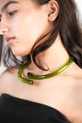 Model wearing handcrafted borosilicate glass choker in green by AIROKAD STUDIO.