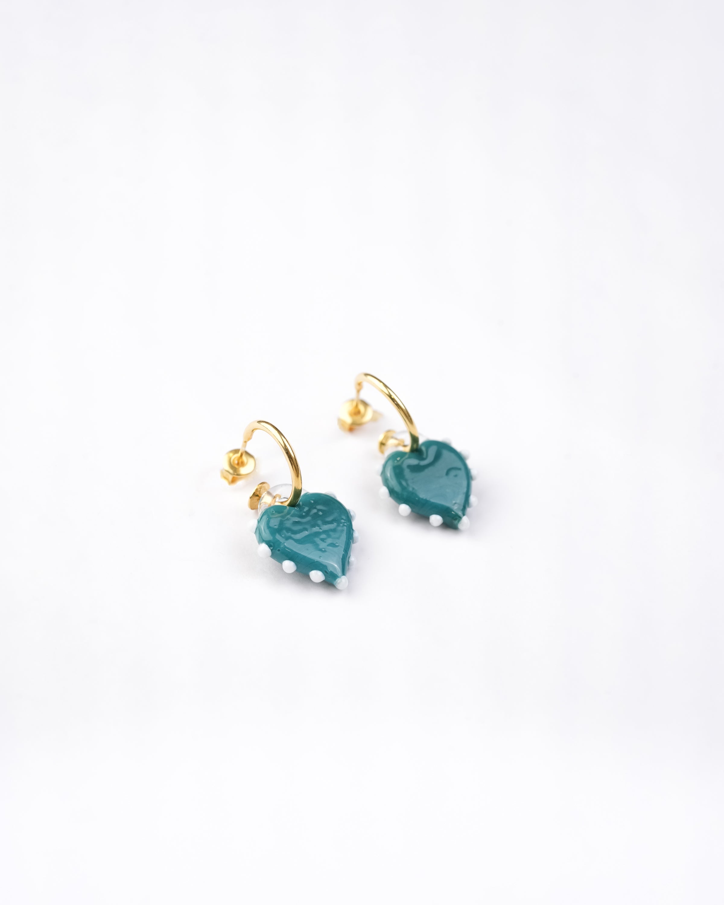 handcrafted borosilicate glass heart shaped hoops in blue with white detailing by AIROKAD STUDIO.