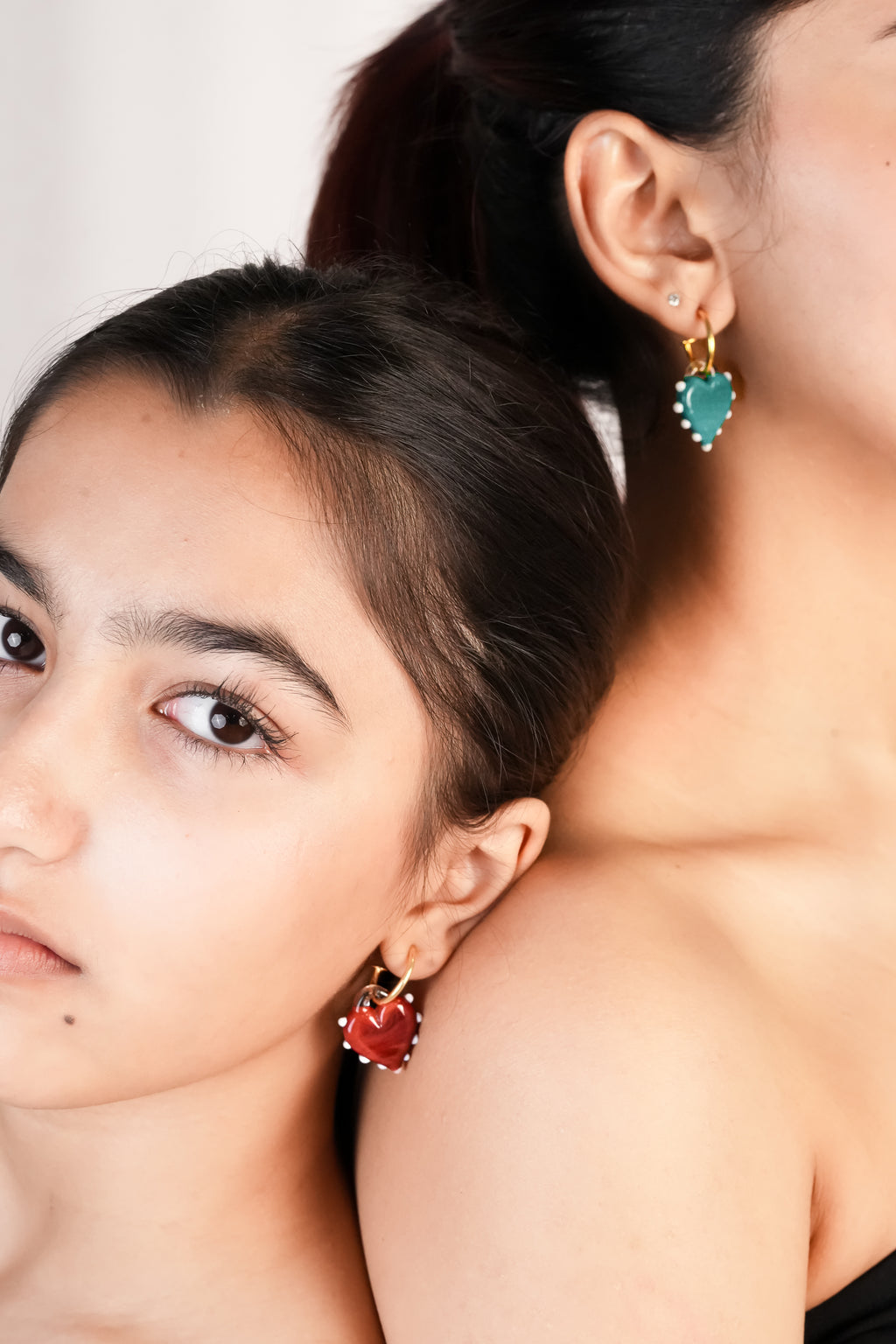 Handmade borosilicate glass hoop earrings in red and blue heart shaped by AIROKAD STUDIO  