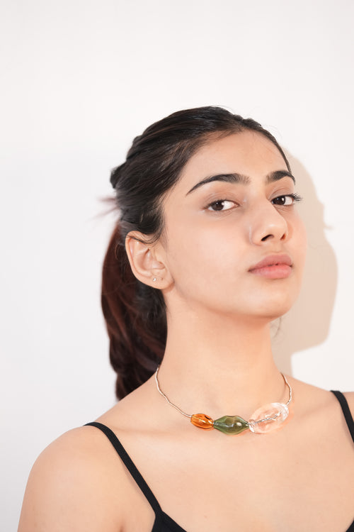 Model wearing borosilicate glass three bubbles choker handmade in amber, teal and transparent with silver hasli by AIROKAD STUDIO.