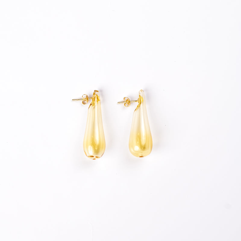 Handmade borosilicate glass earrings in tear drop shape in yellow by AIROKAD STUDIO.