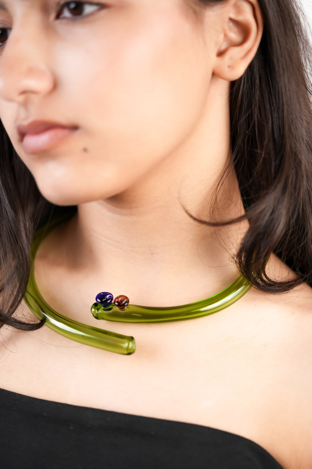 model wearing green pole hasli choker handcrafted with borosilicate glass by AIROKAD STUDIO.