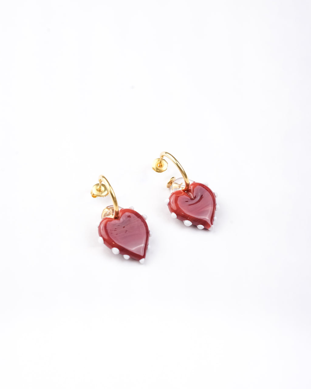 Handcrafted borosilicate glass red heart shaped hoop earrings with white dot detailing by AIROKAD STUDIO.
